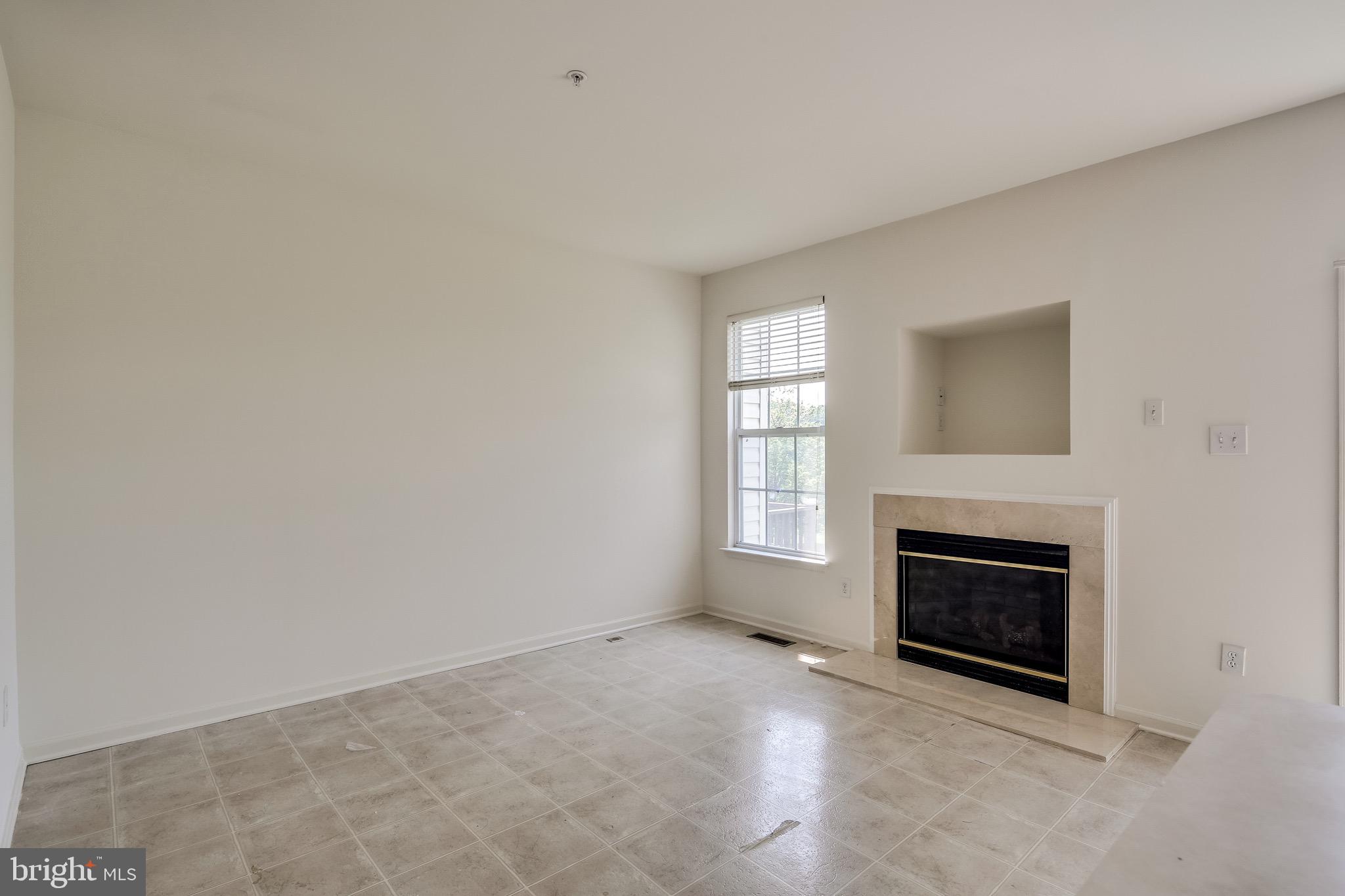 2702 Snowmill Court Ellicott City, MD 21043 - Photo 15 of 34 an empty room with windows and fireplace