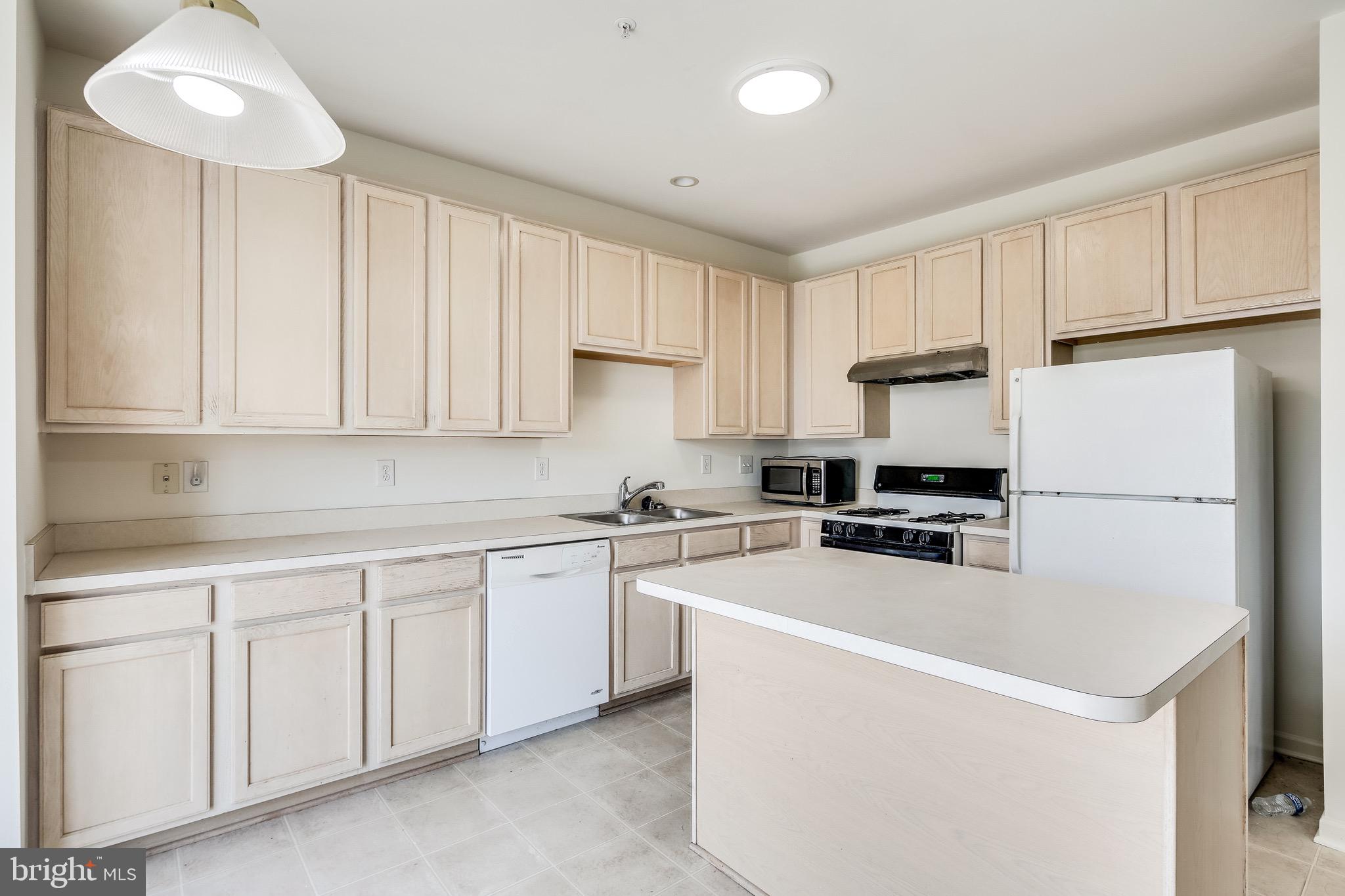 2702 Snowmill Court Ellicott City, MD 21043 - Photo 18 of 34 a kitchen with white cabinets and white appliances