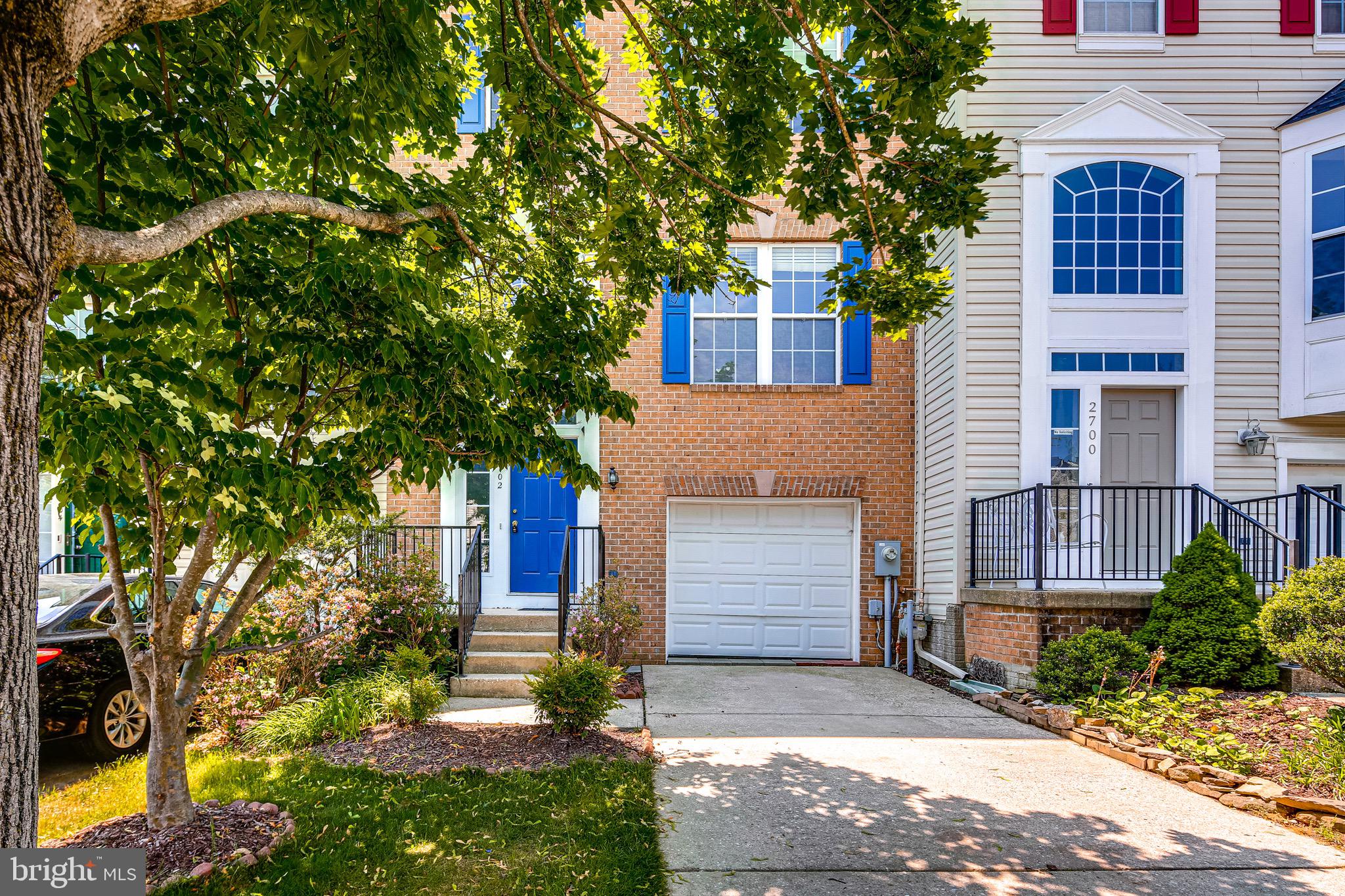 2702 Snowmill Court Ellicott City, MD 21043 - Photo 2 of 34 a front view of a house with a yard and tree s