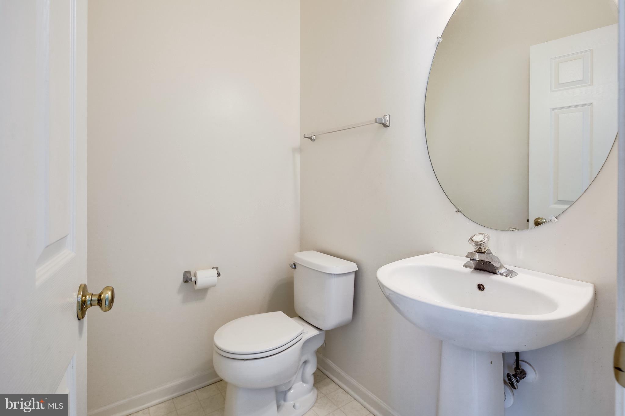 2702 Snowmill Court Ellicott City, MD 21043 - Photo 21 of 34 a bathroom with a sink toilet and a mirror