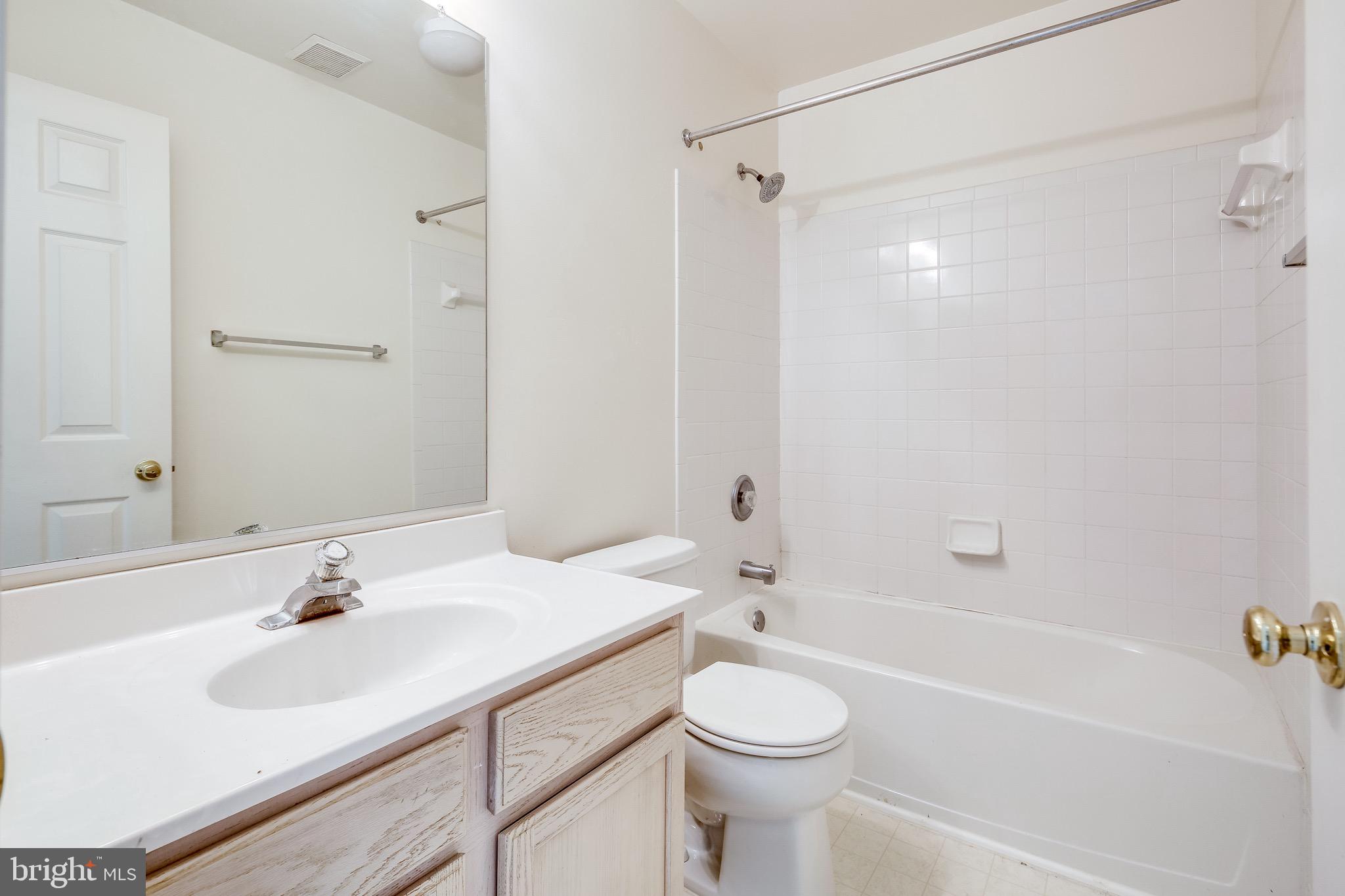 2702 Snowmill Court Ellicott City, MD 21043 - Photo 26 of 34 a bathroom with a sink a toilet and shower