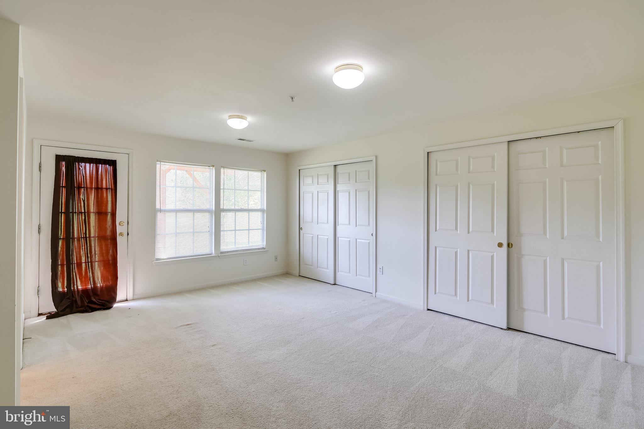 2702 Snowmill Court Ellicott City, MD 21043 - Photo 6 of 34 an empty room with windows and closet