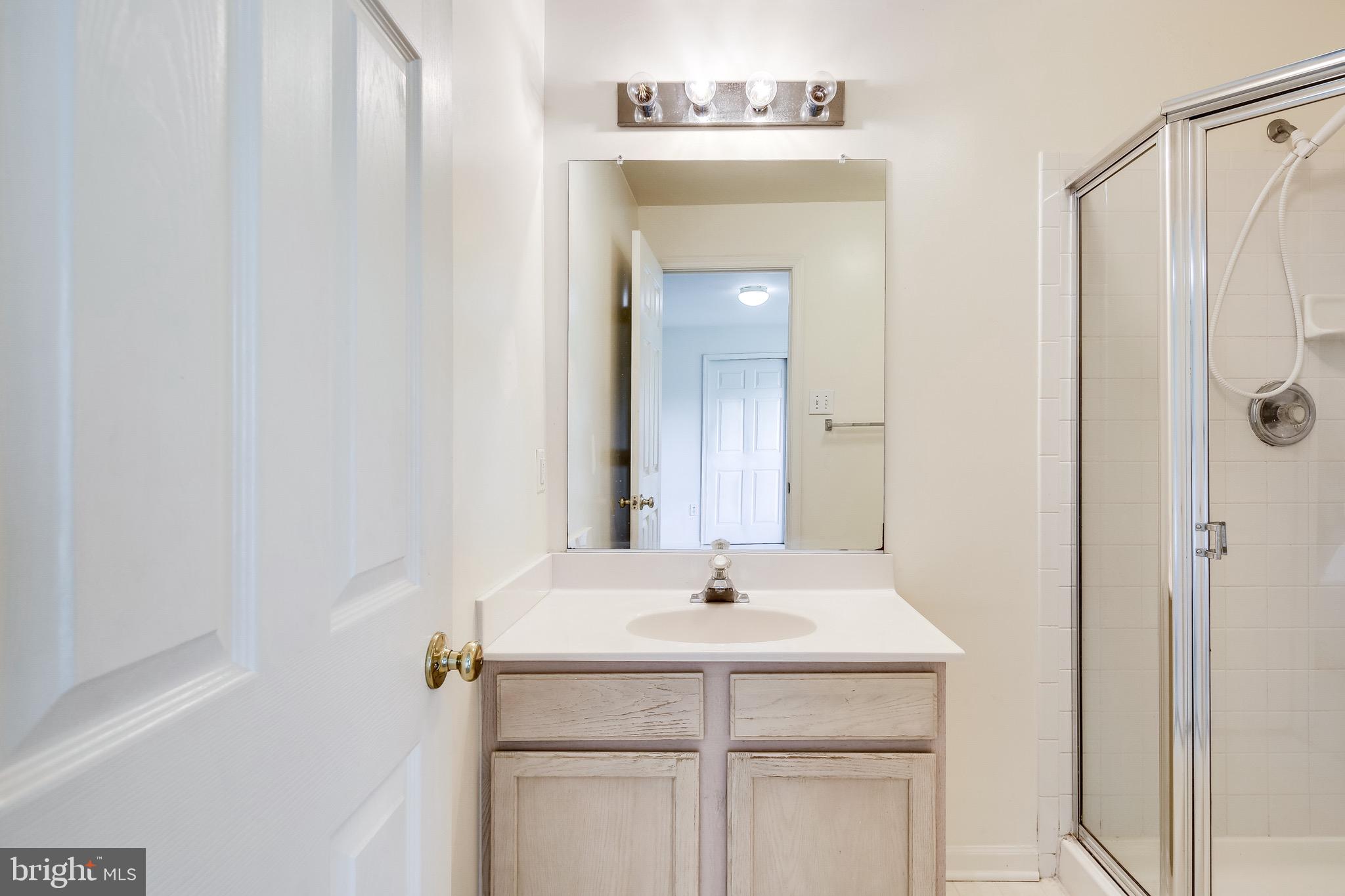 2702 Snowmill Court Ellicott City, MD 21043 - Photo 9 of 34 a bathroom with a sink and a mirror