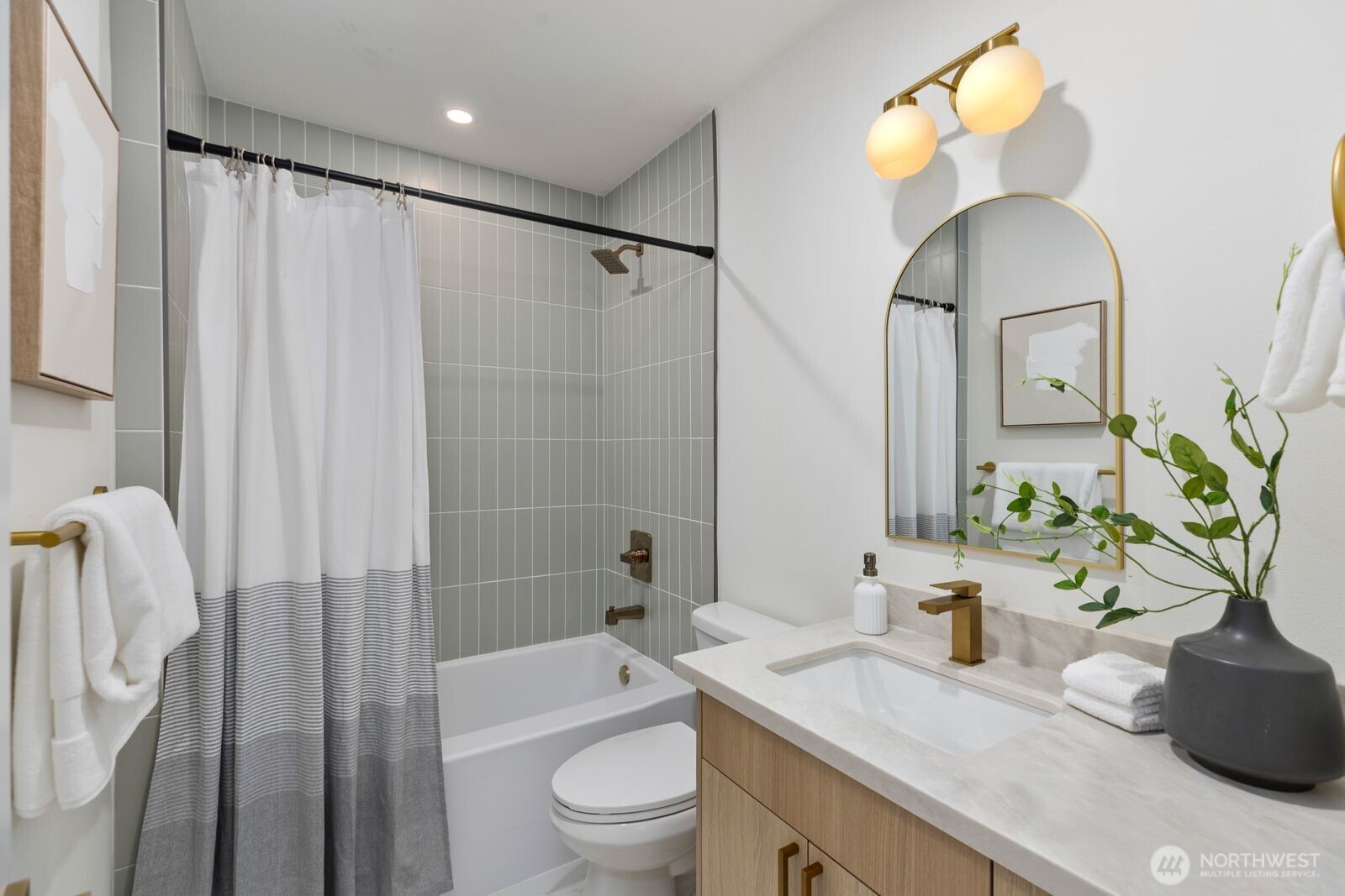 8216 Interlake Avenue North Seattle, WA 98103 - Photo 15 of 36 a bathroom with a granite countertop sink a toilet and a mirror