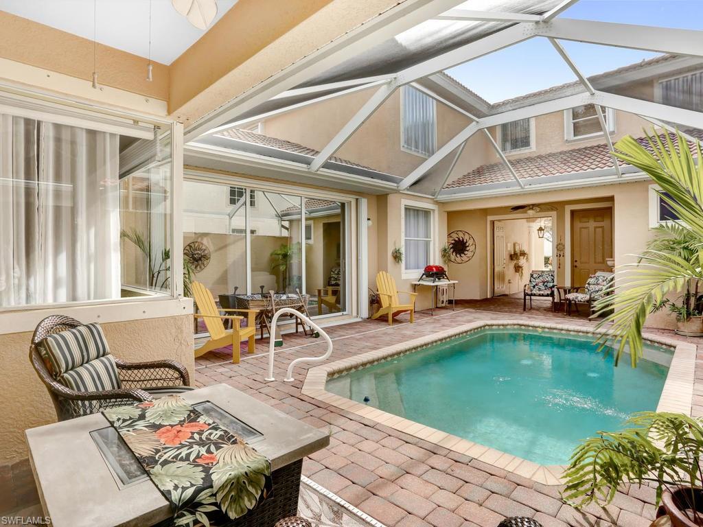 a view of a patio with couches table and chairs and potted plants