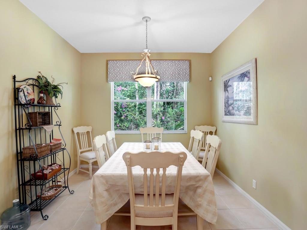 5786 Lago Villaggio Way Naples, FL 34104 - Photo 15 of 29 a view of a dining room with furniture window and outside view