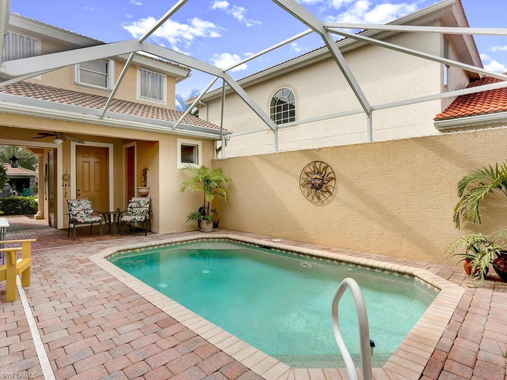 5786 Lago Villaggio Way Naples, FL 34104 - Photo 2 of 29 a swimming pool with potted plants