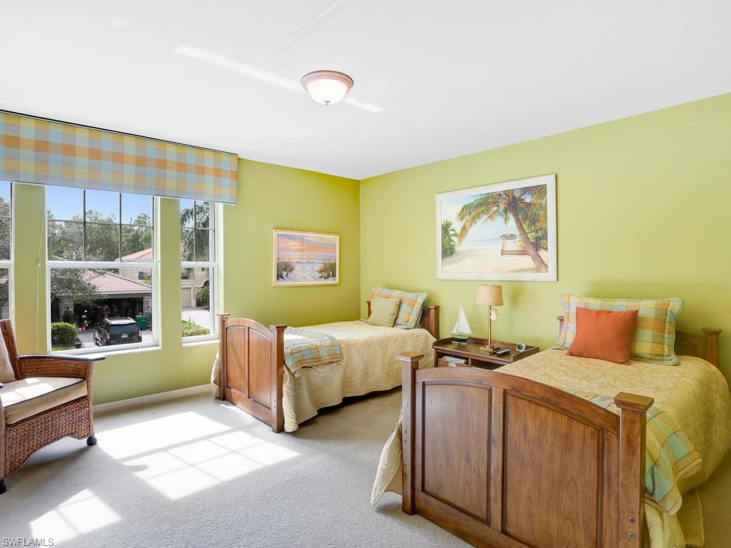 5786 Lago Villaggio Way Naples, FL 34104 - Photo 23 of 29 a bed room with a bed and a large window