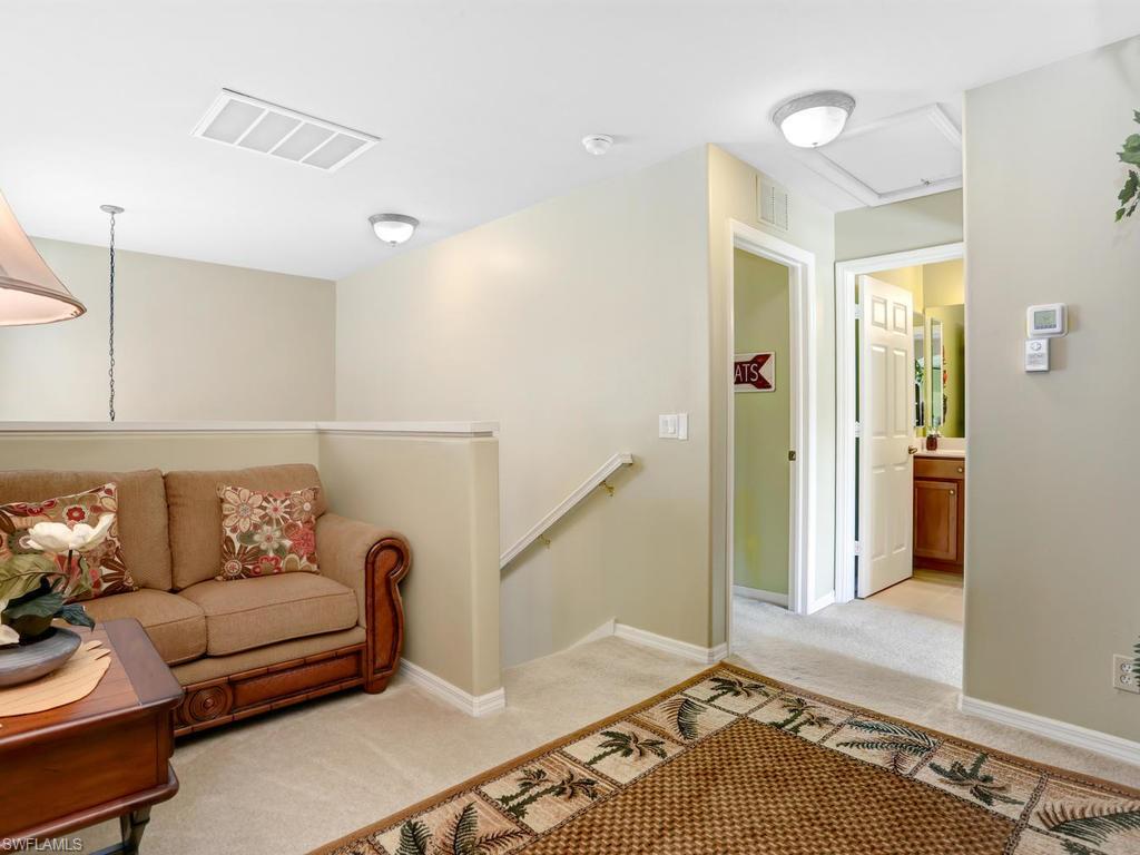 5786 Lago Villaggio Way Naples, FL 34104 - Photo 26 of 29 a living room with furniture and a rug