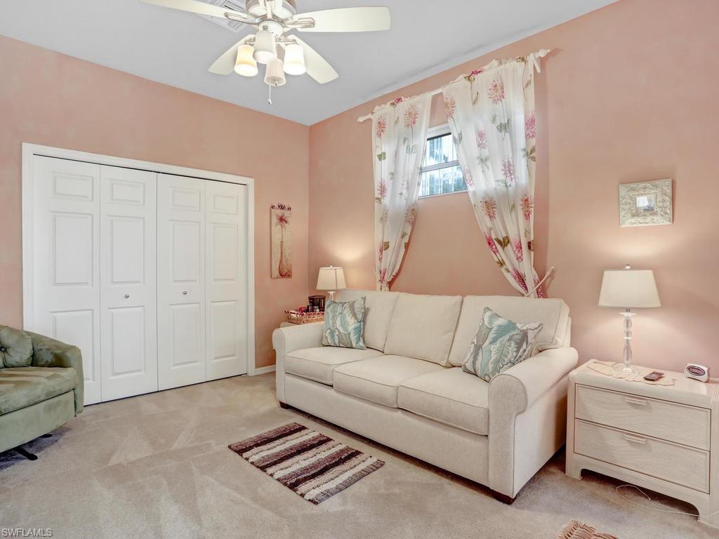 5786 Lago Villaggio Way Naples, FL 34104 - Photo 27 of 29 a living room with furniture and a chandelier