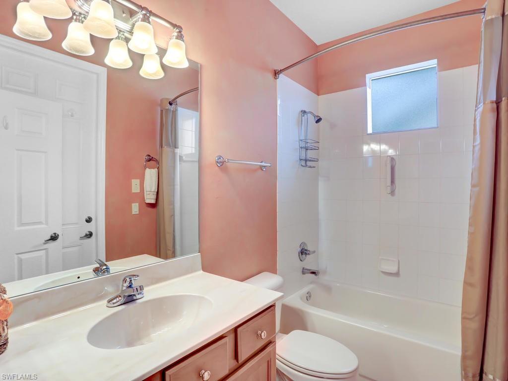 5786 Lago Villaggio Way Naples, FL 34104 - Photo 28 of 29 a bathroom with a sink toilet tub and shower