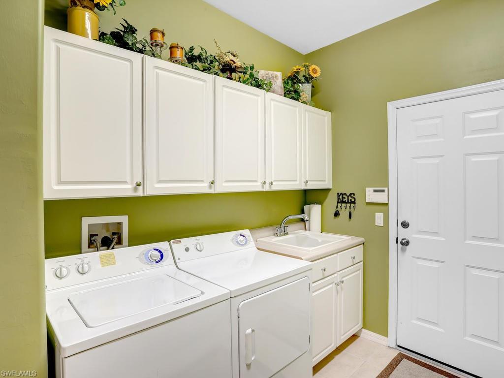 5786 Lago Villaggio Way Naples, FL 34104 - Photo 29 of 29 a utility room with dryer and washer