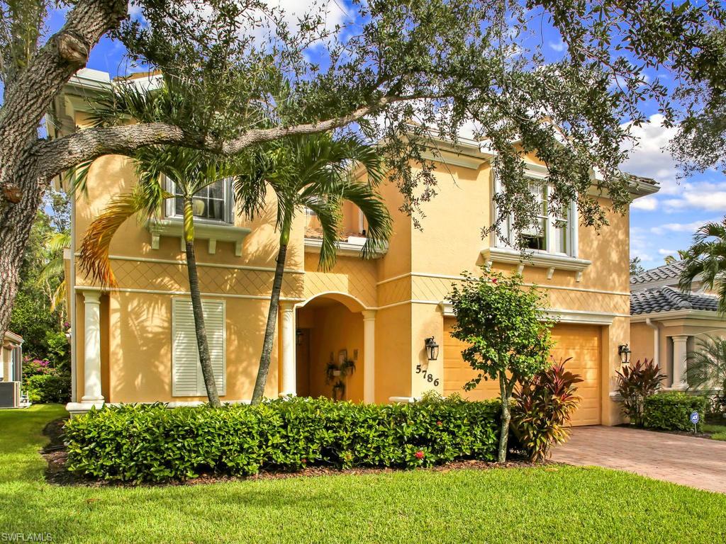 5786 Lago Villaggio Way Naples, FL 34104 - Photo 4 of 29 a front view of a house with a yard