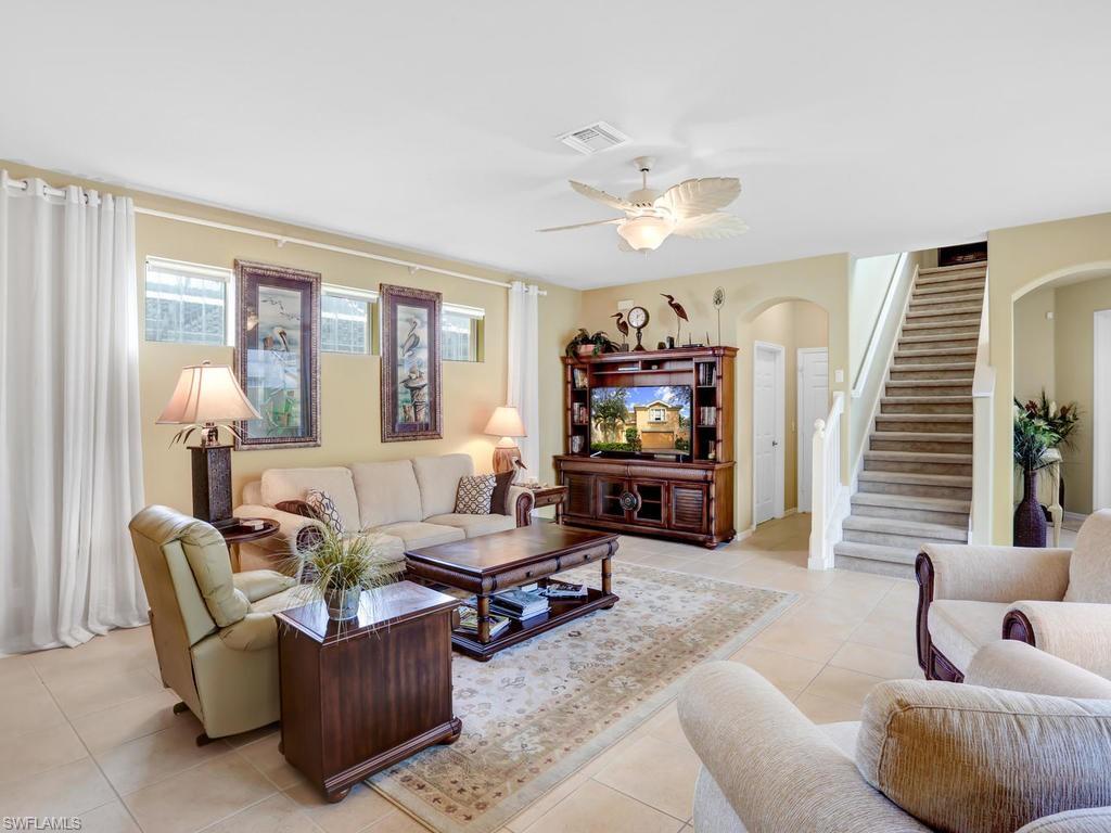 5786 Lago Villaggio Way Naples, FL 34104 - Photo 7 of 29 a living room with furniture and a flat screen tv