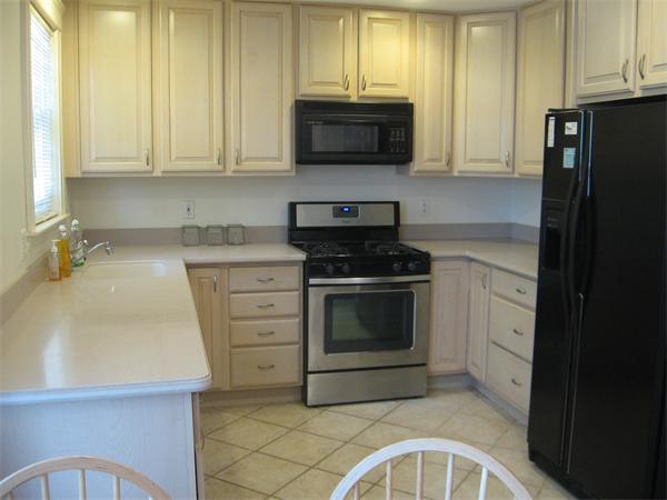 47 Algonquin Road Newton, MA 02467 - Photo 3 of 15 a kitchen with stainless steel appliances granite countertop a stove a microwave and a refrigerator