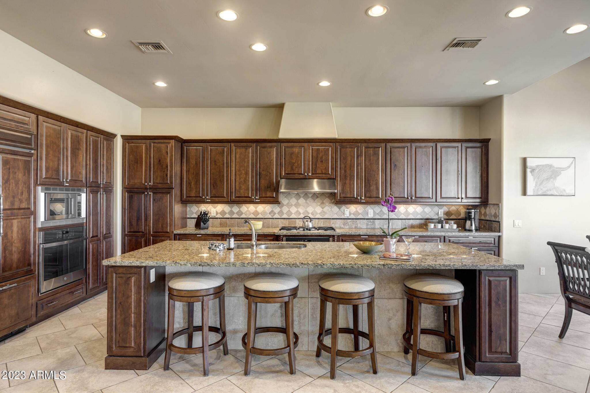 14214 East Gamble Lane Scottsdale, AZ 85262 - Photo 12 of 53 a kitchen with stainless steel appliances granite countertop a table chairs sink refrigerator and cabinets