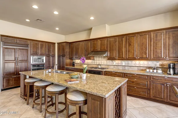 a kitchen with granite countertop a sink and cabinets