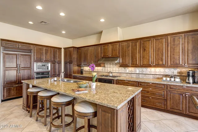 a kitchen with granite countertop a sink and cabinets