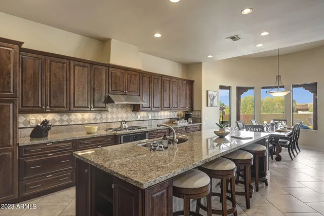 a kitchen with counter space dining table and chairs