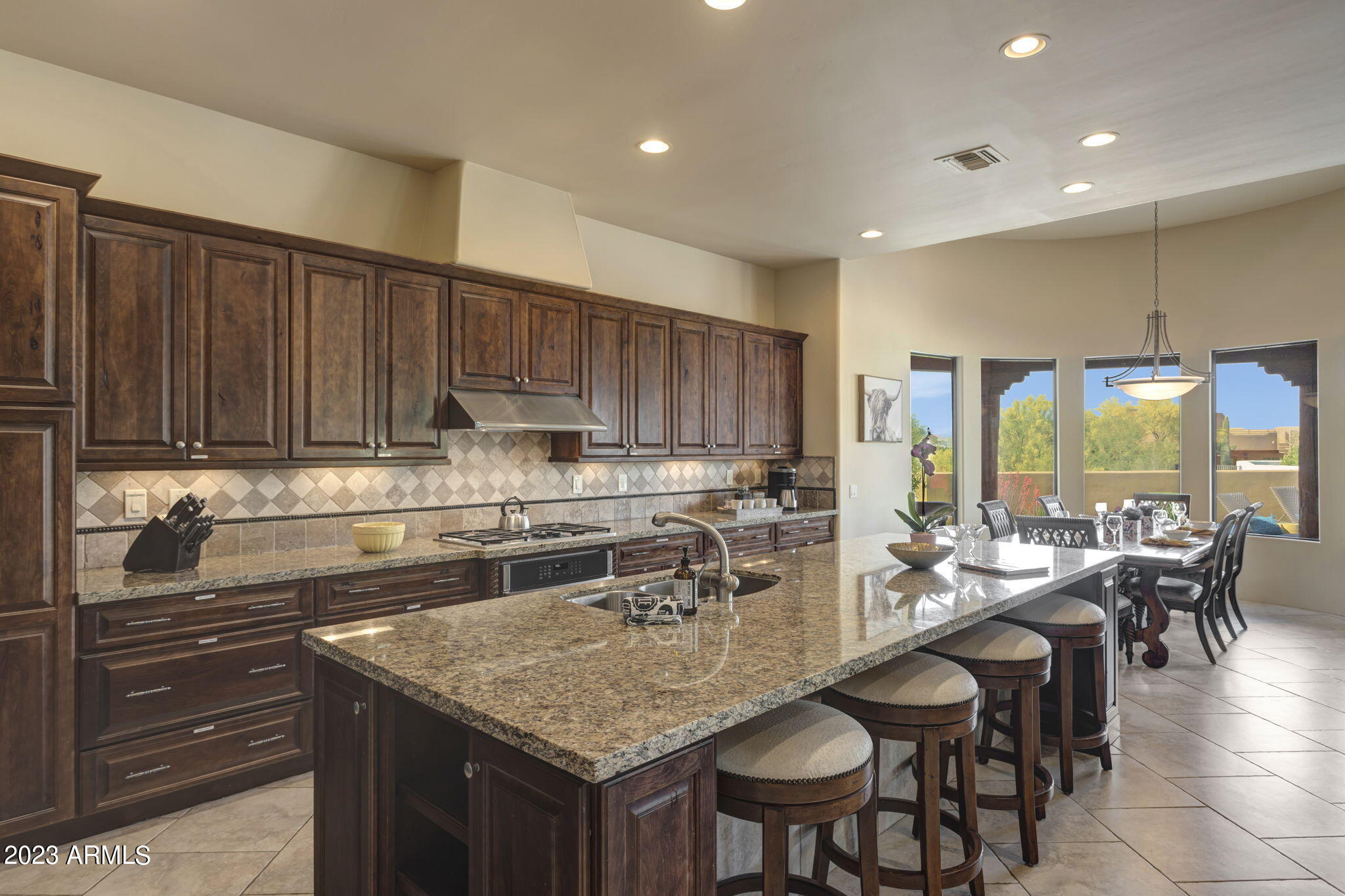 14214 East Gamble Lane Scottsdale, AZ 85262 - Photo 14 of 53 a kitchen with counter space dining table and chairs