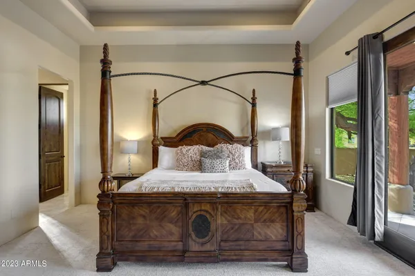 a bedroom with a bed and large mirror