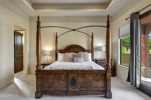 a bedroom with a bed and large mirror