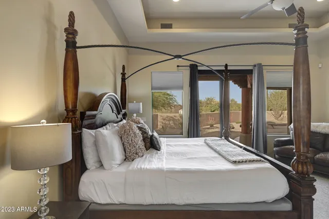 a bedroom with a large bed and a chandelier