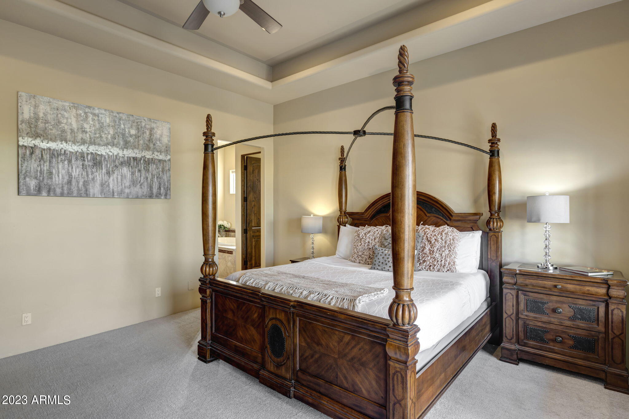 14214 East Gamble Lane Scottsdale, AZ 85262 - Photo 21 of 53 a bedroom with a large bed and a chandelier