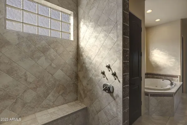 a bathroom with double vanity sinks a vanity a lamp and a bathtub