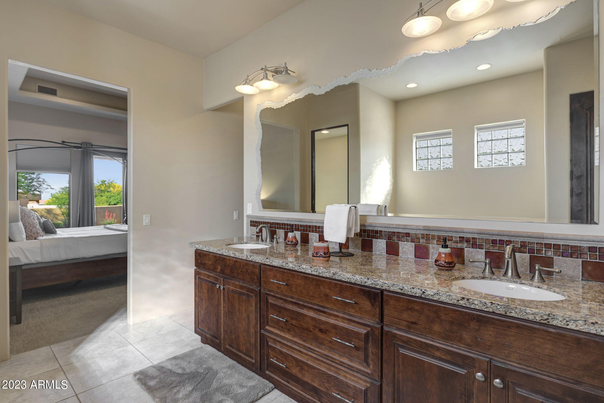14214 East Gamble Lane Scottsdale, AZ 85262 - Photo 25 of 53 a bathroom with double vanity sinks a vanity a lamp and a bathtub