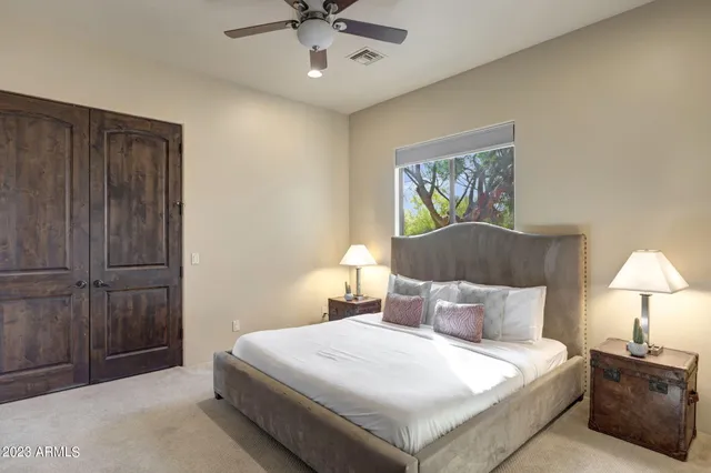 a bedroom with a bed and a chandelier