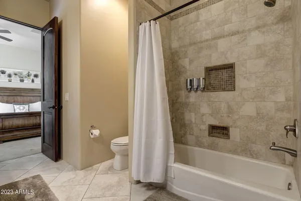 a room with pool table and windows