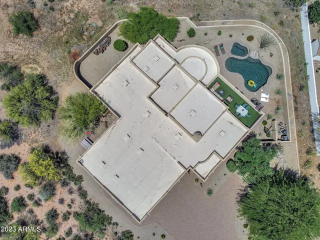 an aerial view of a house with a swimming pool