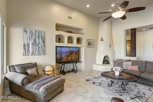 a living room with furniture and a chandelier
