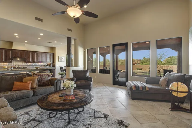a living room with furniture and a large window with garden view