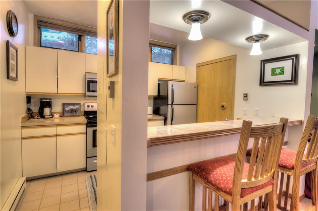 2017 Soda Ridge Road, Unit 1943 Keystone, CO 80435 - Photo 13 of 21 a kitchen with stainless steel appliances granite countertop a refrigerator and a stove