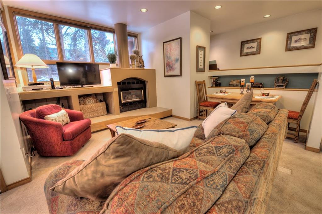 2017 Soda Ridge Road, Unit 1943 Keystone, CO 80435 - Photo 7 of 21 a living room with furniture a fireplace and a flat screen tv