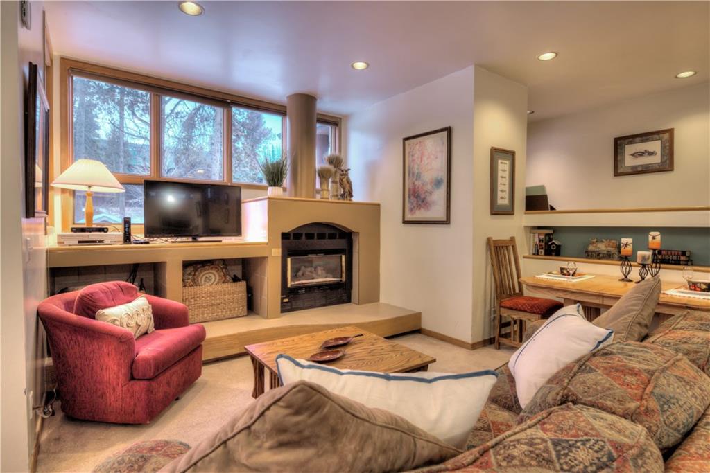 2017 Soda Ridge Road, Unit 1943 Keystone, CO 80435 - Photo 8 of 21 a living room with furniture a fireplace and a flat screen tv