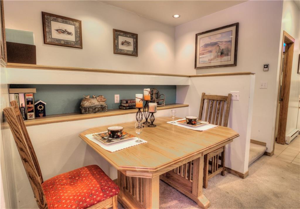 2017 Soda Ridge Road, Unit 1943 Keystone, CO 80435 - Photo 9 of 21 a kitchen with a table chairs and a refrigerator