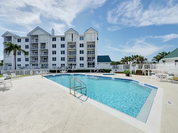 a swimming pool with outdoor seating and yard