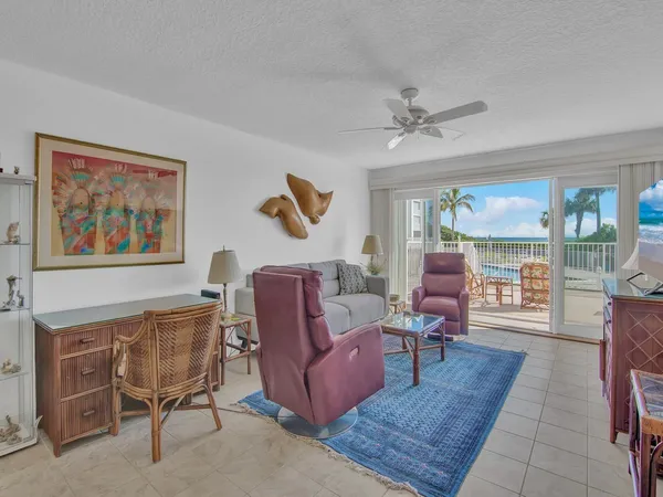 a living room with furniture a chandelier and a window