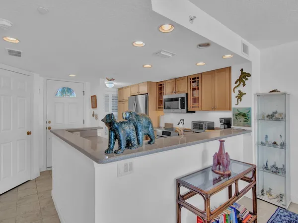 a kitchen with granite countertop a sink and cabinets
