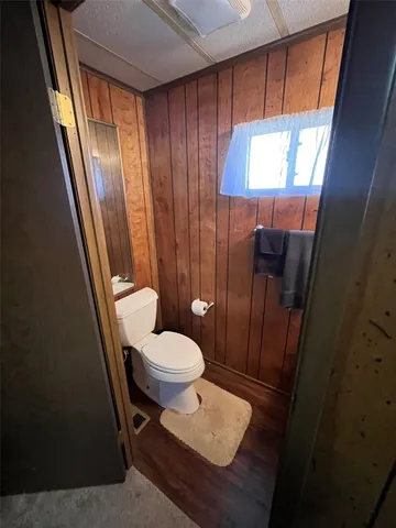 a bathroom with a sink a toilet a mirror and vanity