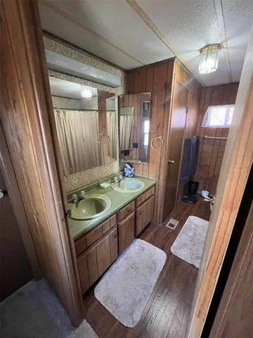 a bathroom with a sink a mirror and a shower