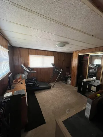 a room with gym equipment and a flat screen tv
