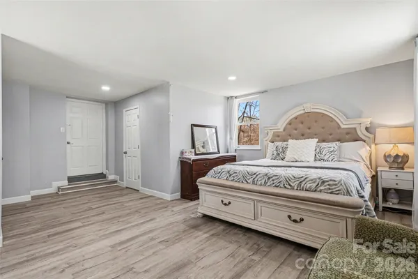 a spacious bedroom with a bed and a dresser