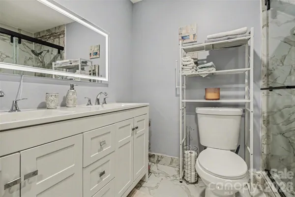 a bathroom with a toilet sink and mirror