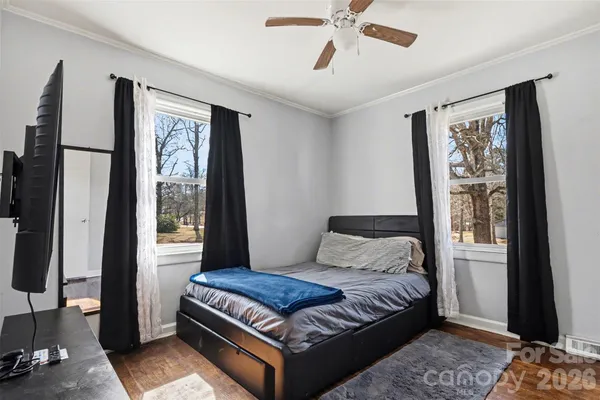 a bedroom with a large bed and a window