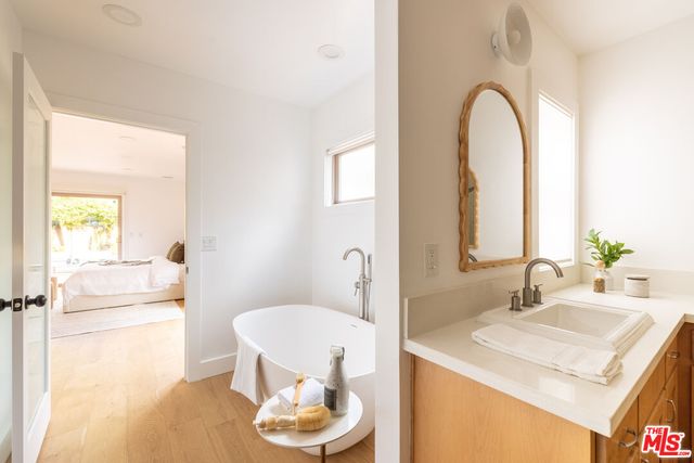 a bathroom with a granite countertop sink a toilet and a mirror