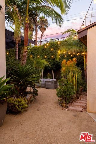 a view of a patio with couches and potted plants
